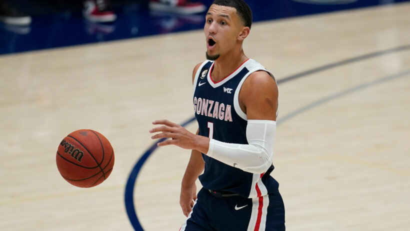 Gonzaga guard Jalen Suggs dribbling the ball up the court during a NCAA men's basketball game.