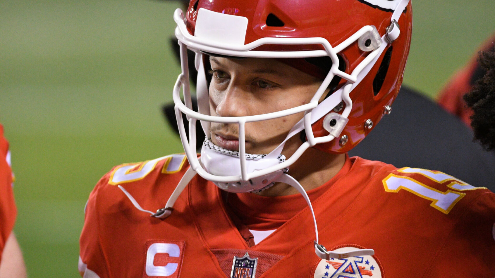 A close up shot of Patrick Mahomes on the sidelines during a football game.