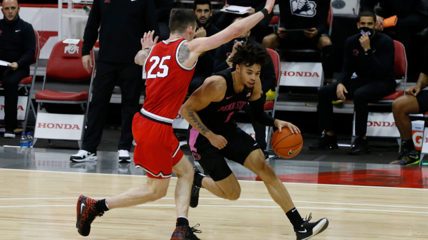 Seth Lundy dribbling trying to get around defender