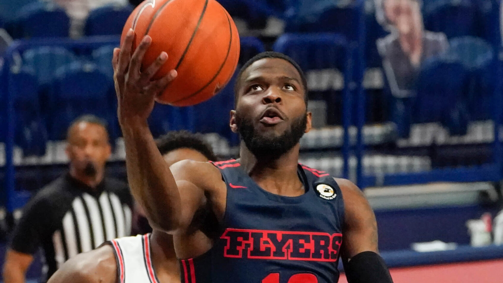Dayton's Jalen Crutcher going up for a layup against Duquesne in a NCAA men's basketball game.