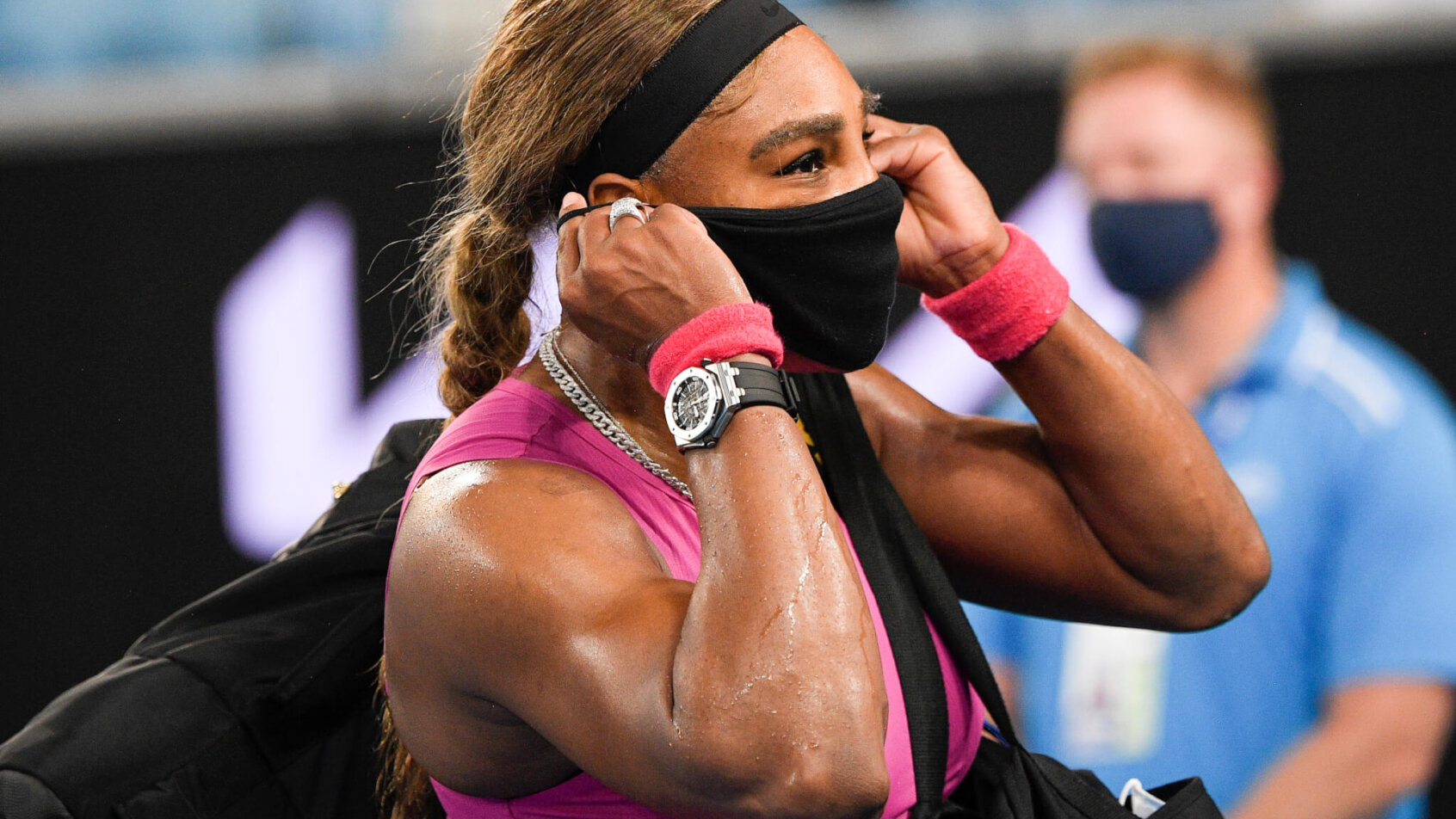 Serena Williams adjusting her mask as she leave the court following a match.