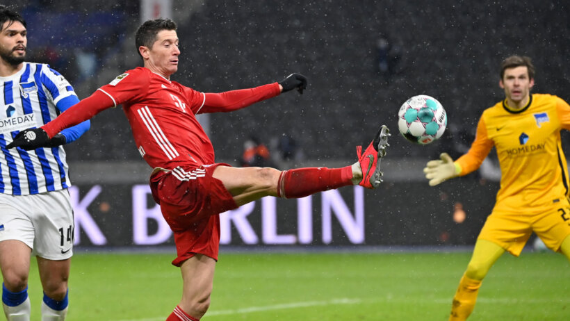 Bayern's Robert Lewandowski kicking the ball with a high kick during a soccer match