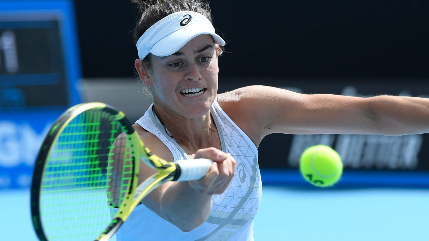 United States' Jennifer Brady stretching to make a forehand return against her opponent during a tennis match.
