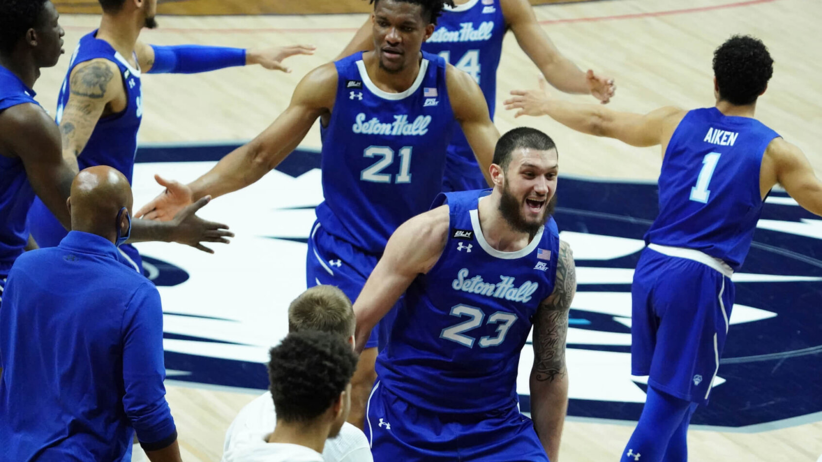 Seton Hall players reacting after winning a NCAA men's basketballl game.