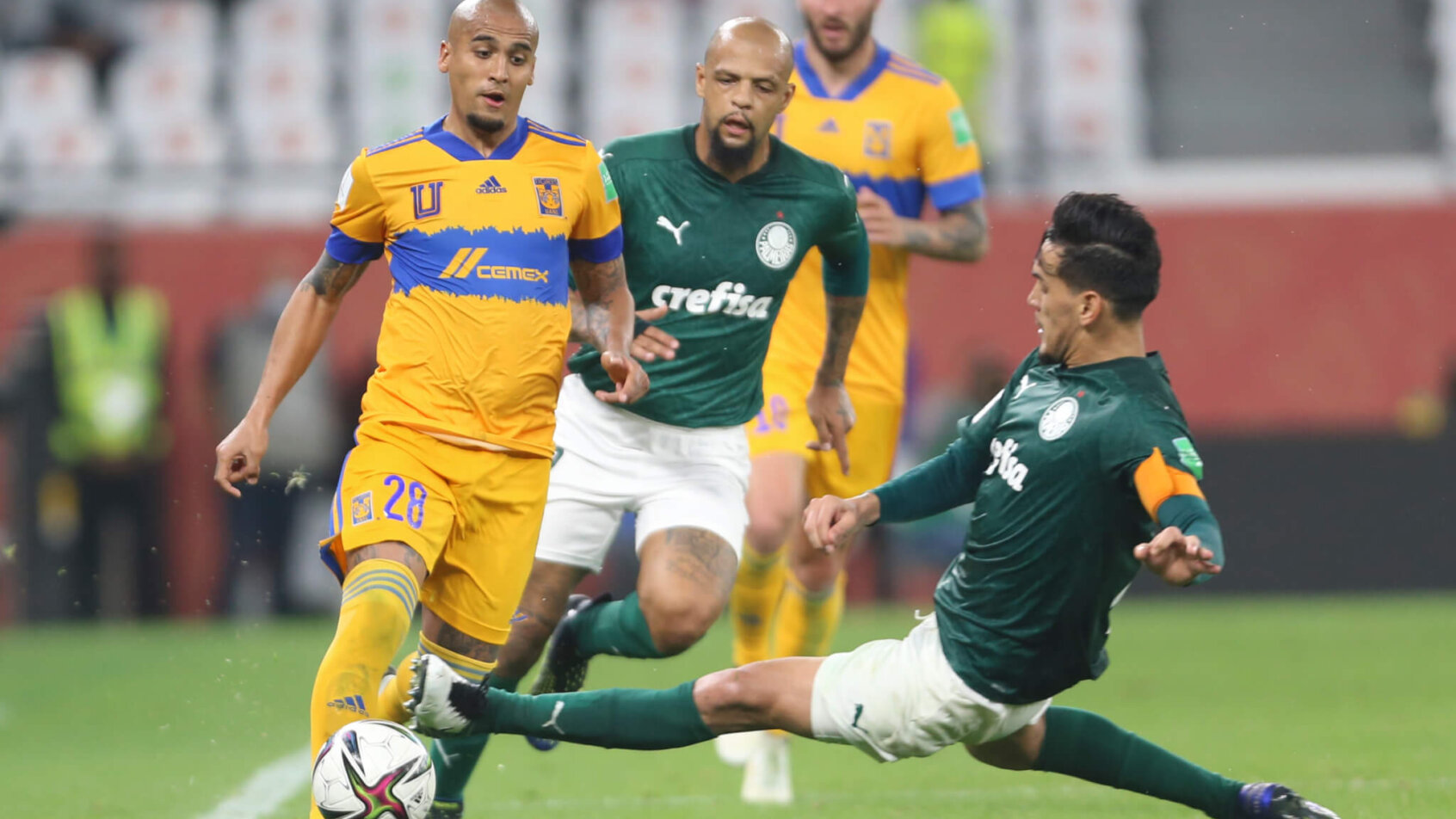 Gustavo Gomez of Brazil's Palmeiras tackling Luis Rodriguez of Tigres UANL during a soccer match.