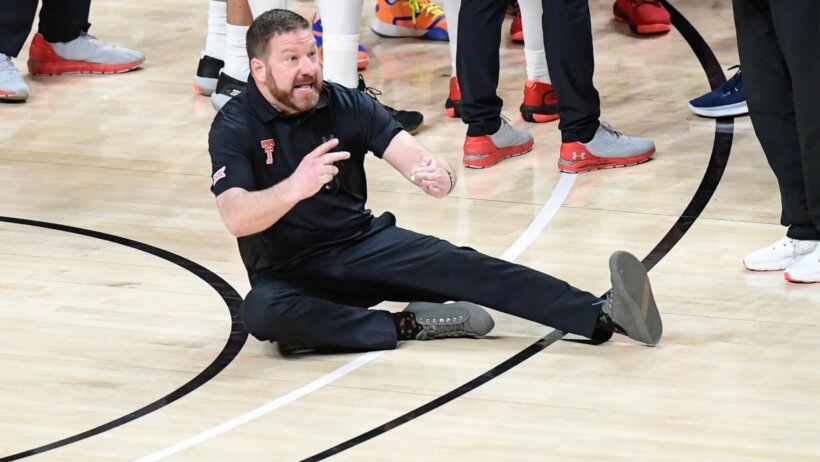 Chris Beard sitting on the court in anger