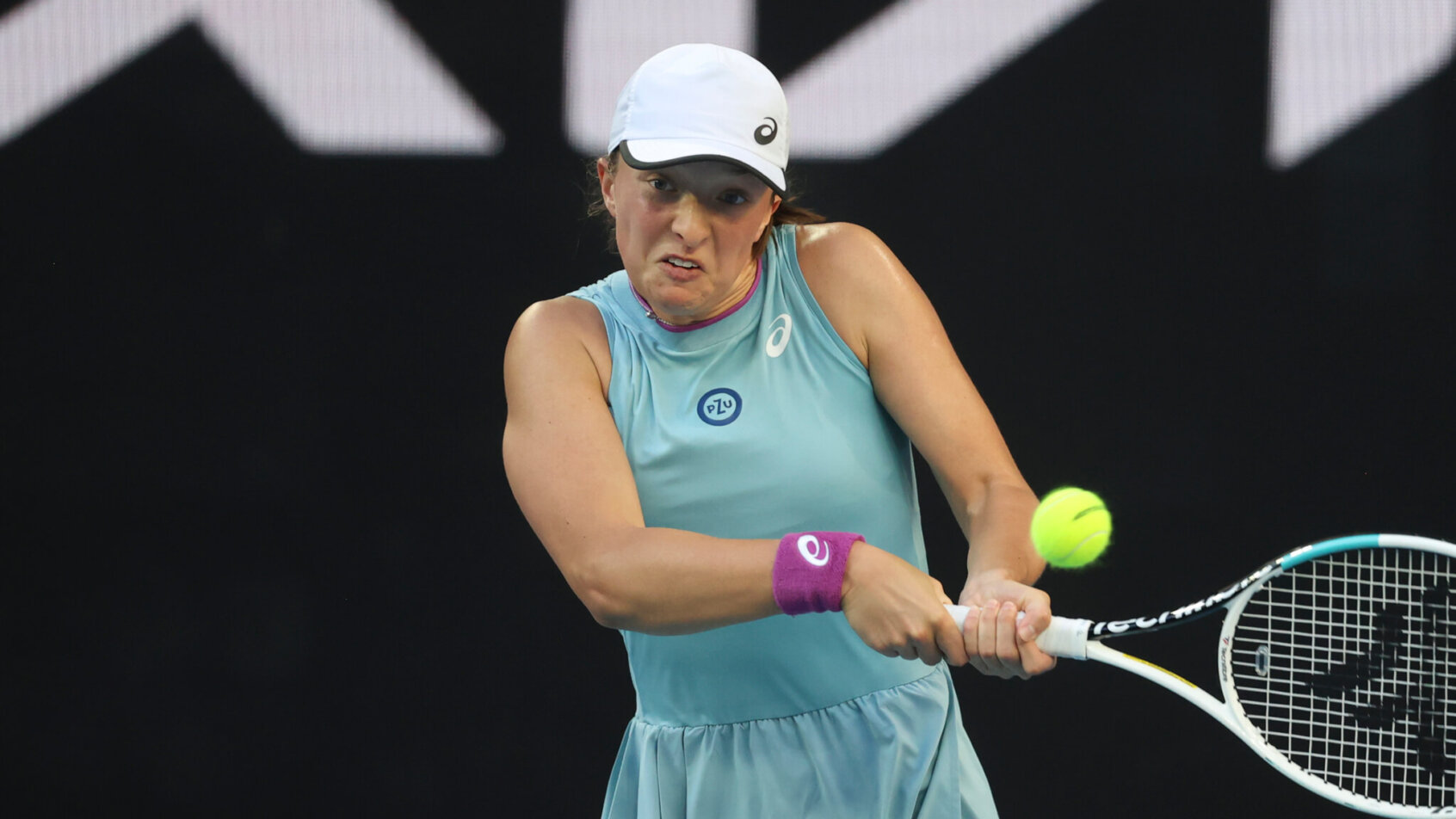 Iga Swiatek making a backhand return during a tennis match