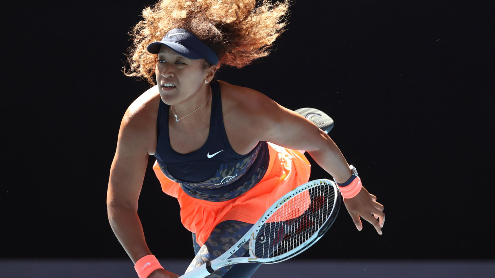 Naomi Osaka following through on a serve during a match at the 2021 Australian Open.