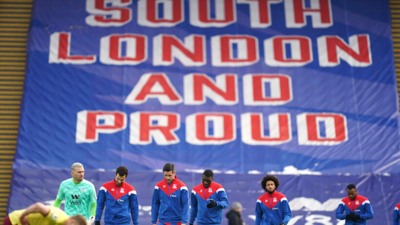Crystal Palace players arriving and walking on the field ahead of their English Premier League soccer match.