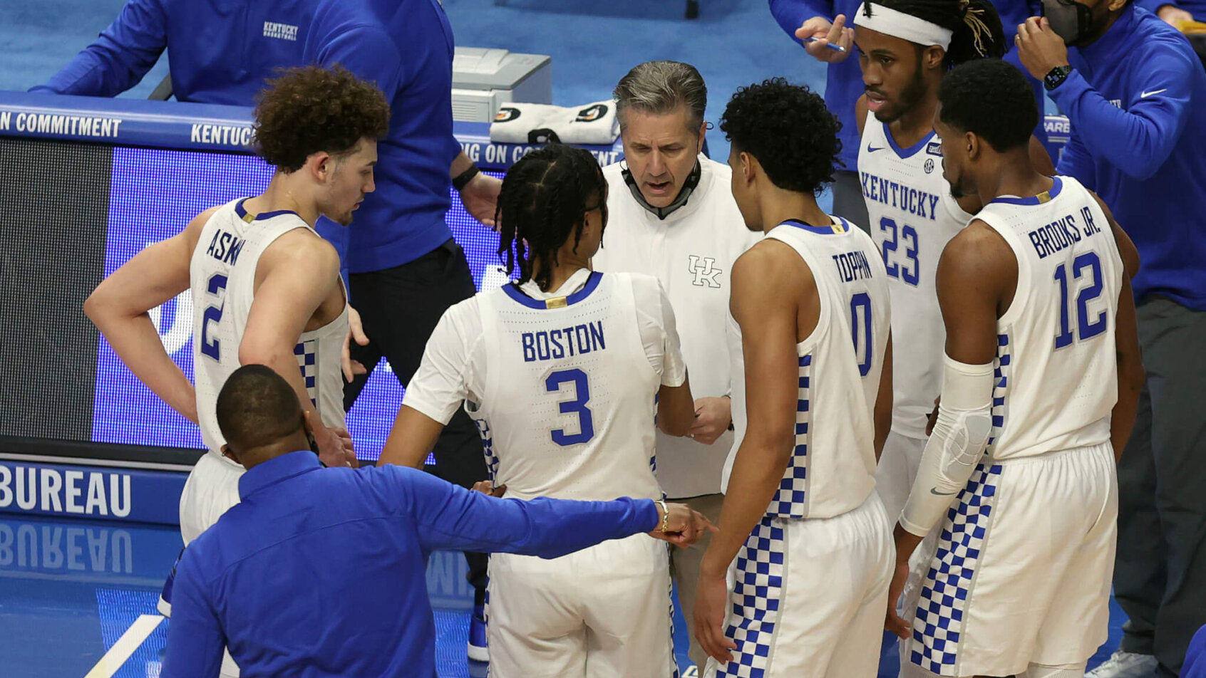 John Calipari with players huddled around him