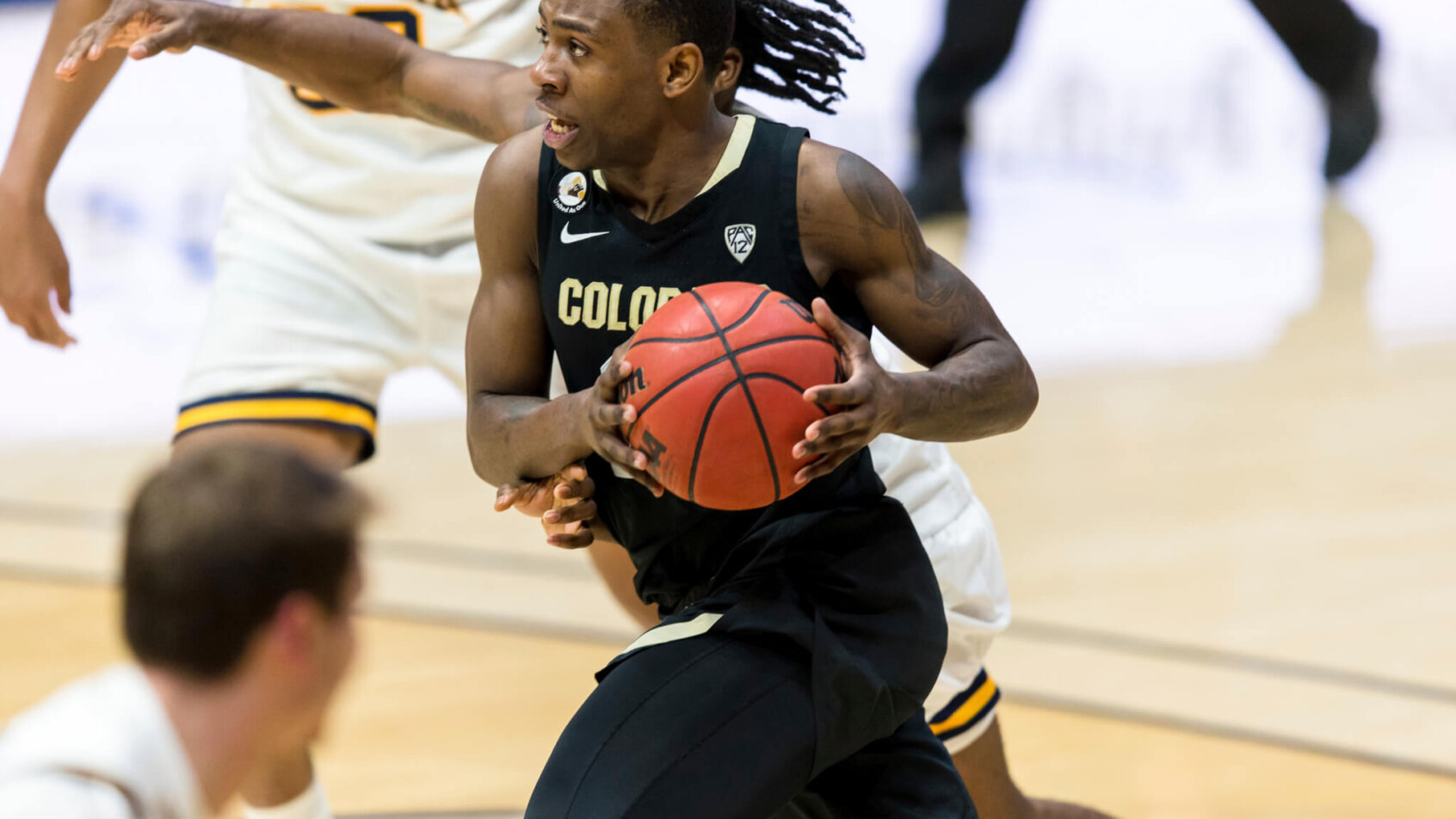 Colorado guard McKinley Wright IV driving to the basket during a game.