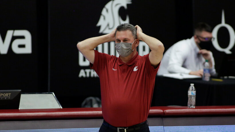 Kyle Smith wearing mask, hands on head