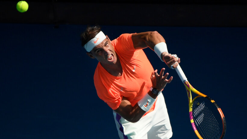 Rafael Nadal with a follow through on his serve during a match at the 2021 Australian Open.
