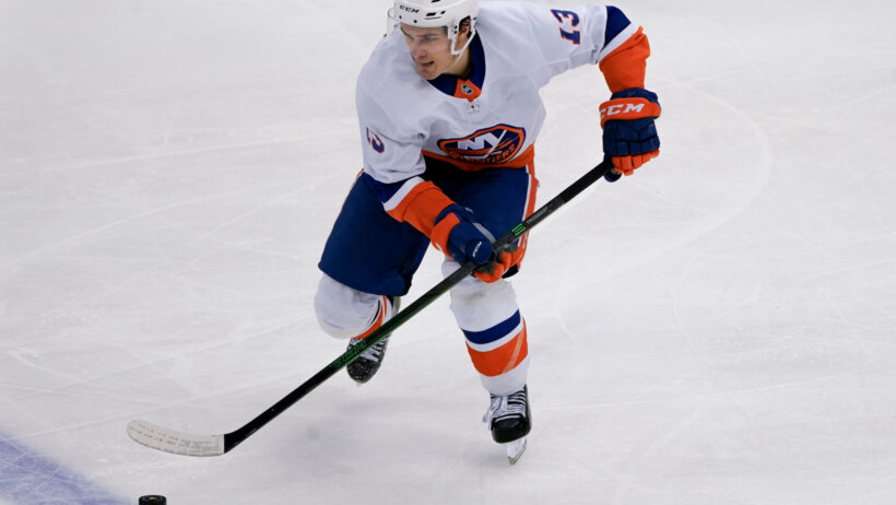New York Islanders' Mathew Barzal skating on the ice during a NHL game.