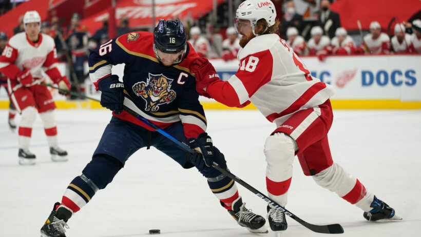 Detroit Red Wings defenseman Marc Staal pushing Florida Panthers center Aleksander Barkov off the puck during an NHL game.