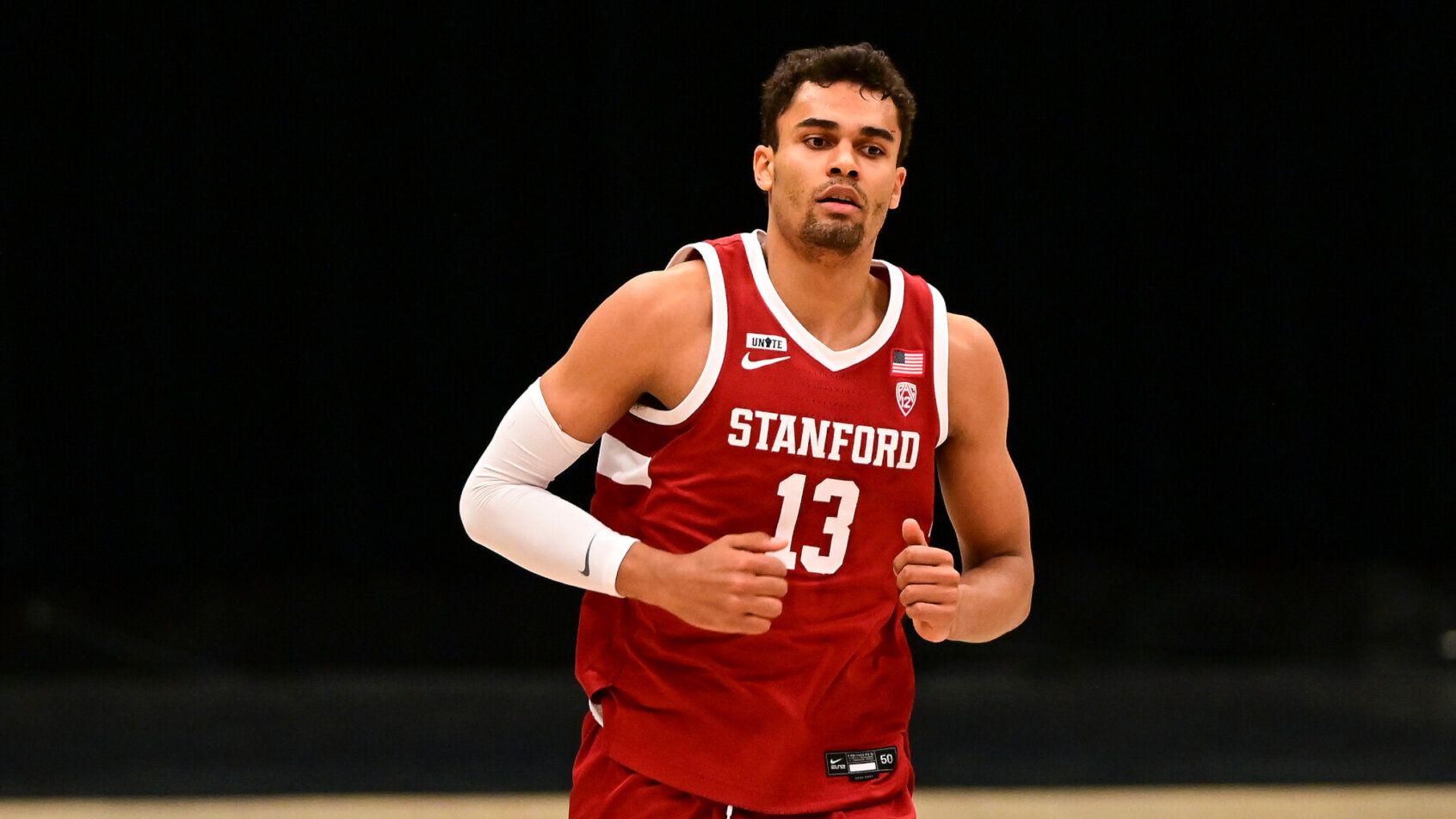 Stanford forward Oscar da Silva jogging on the court during a game.
