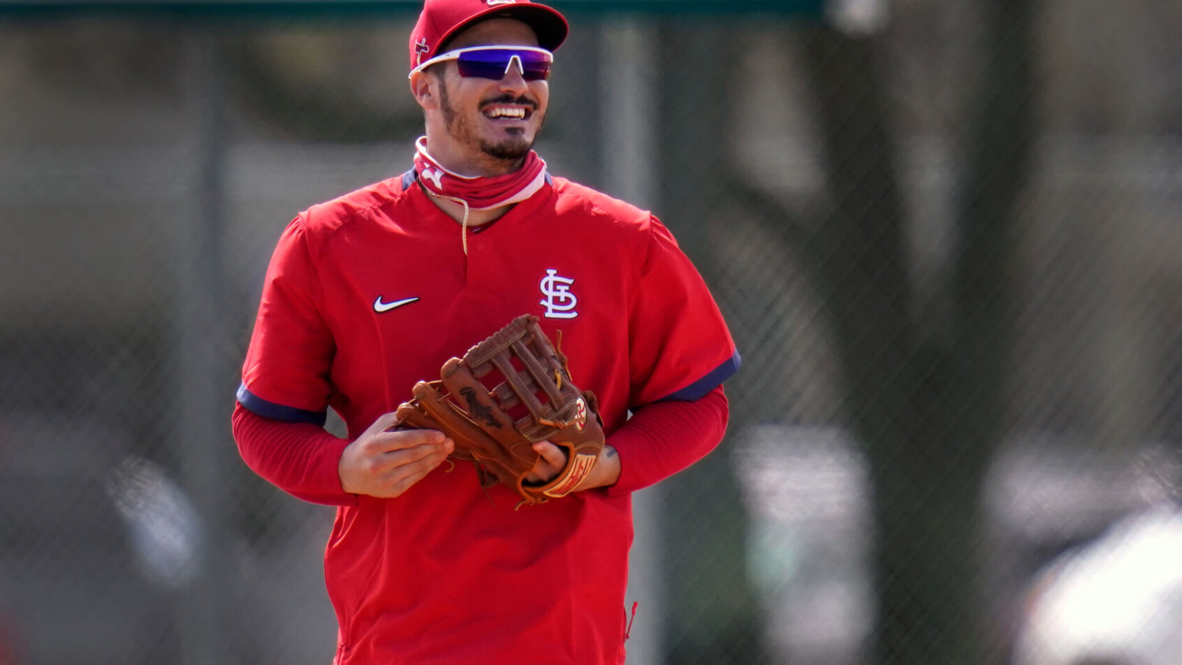 St. Louis Cardinals infielder Nolan Arenado smiles as he jogs out to his position during spring training