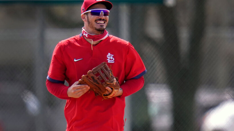St. Louis Cardinals infielder Nolan Arenado smiles as he jogs out to his position during spring training
