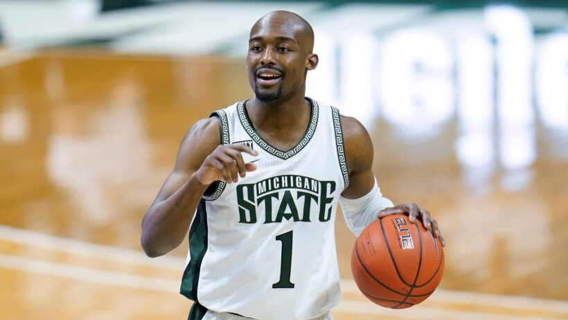 Michigan State guard Joshua Langford dribbling the ball up the court during a game.