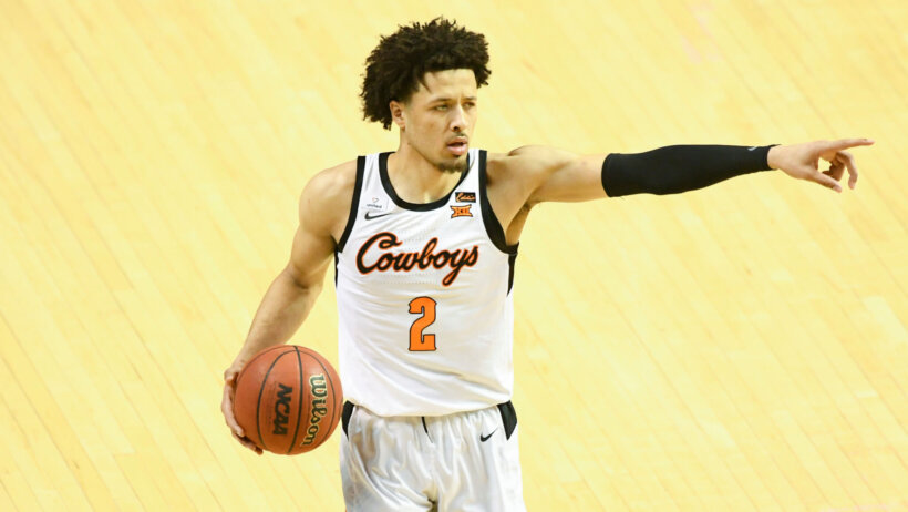 Cade Cunningham holding ball on hip and pointing with left hand