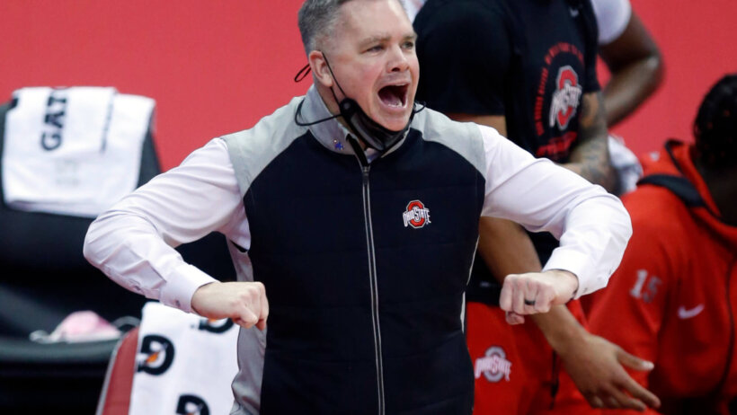 Chris Holtmann mask down yelling on the court