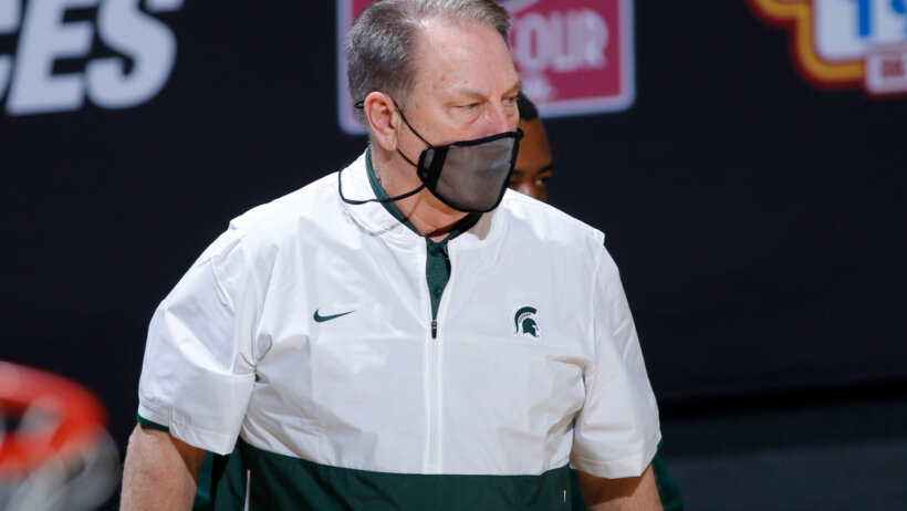 Tom Izzo mask on, standing on sideline