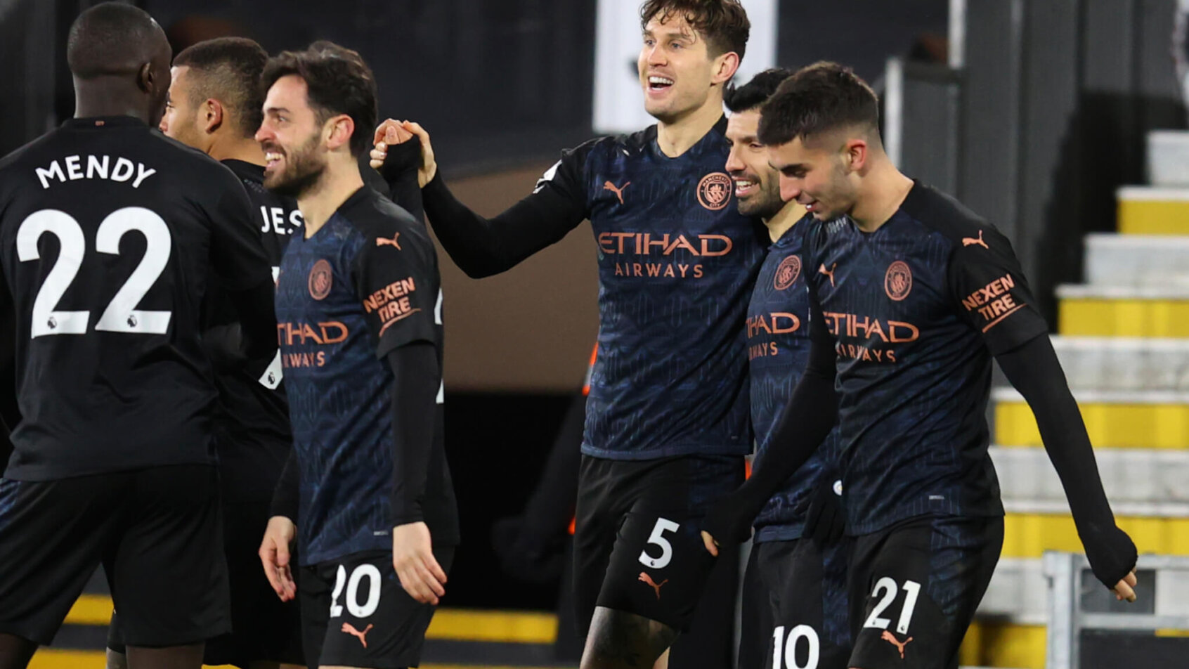 Manchester City's John Stones celebrating with teammates after scoring the opening goal during a soccer match.