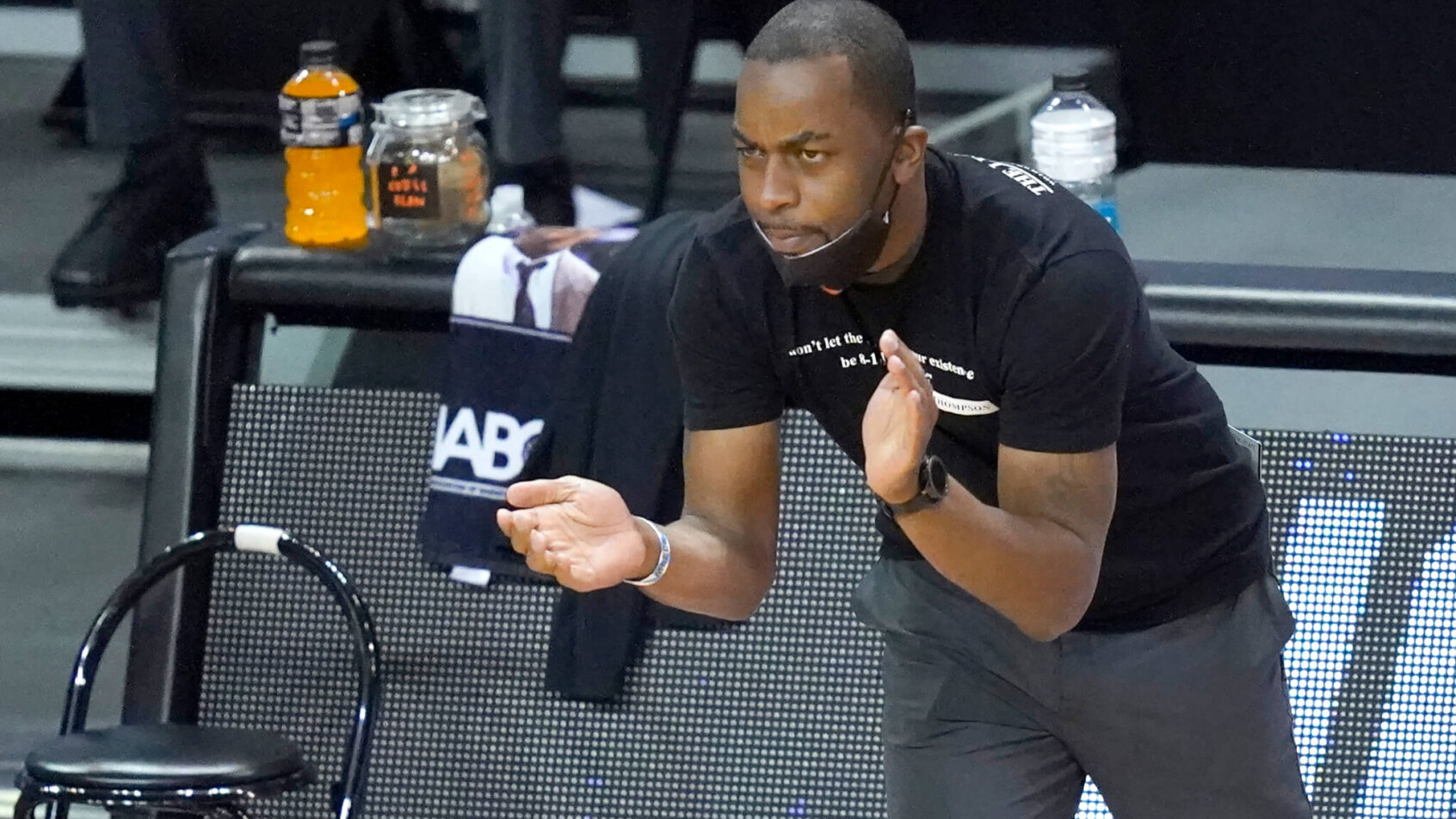 Oklahoma State head coach Mike Boynton clapping on his team from the sidelines during a NCAA college tournament basketball game.