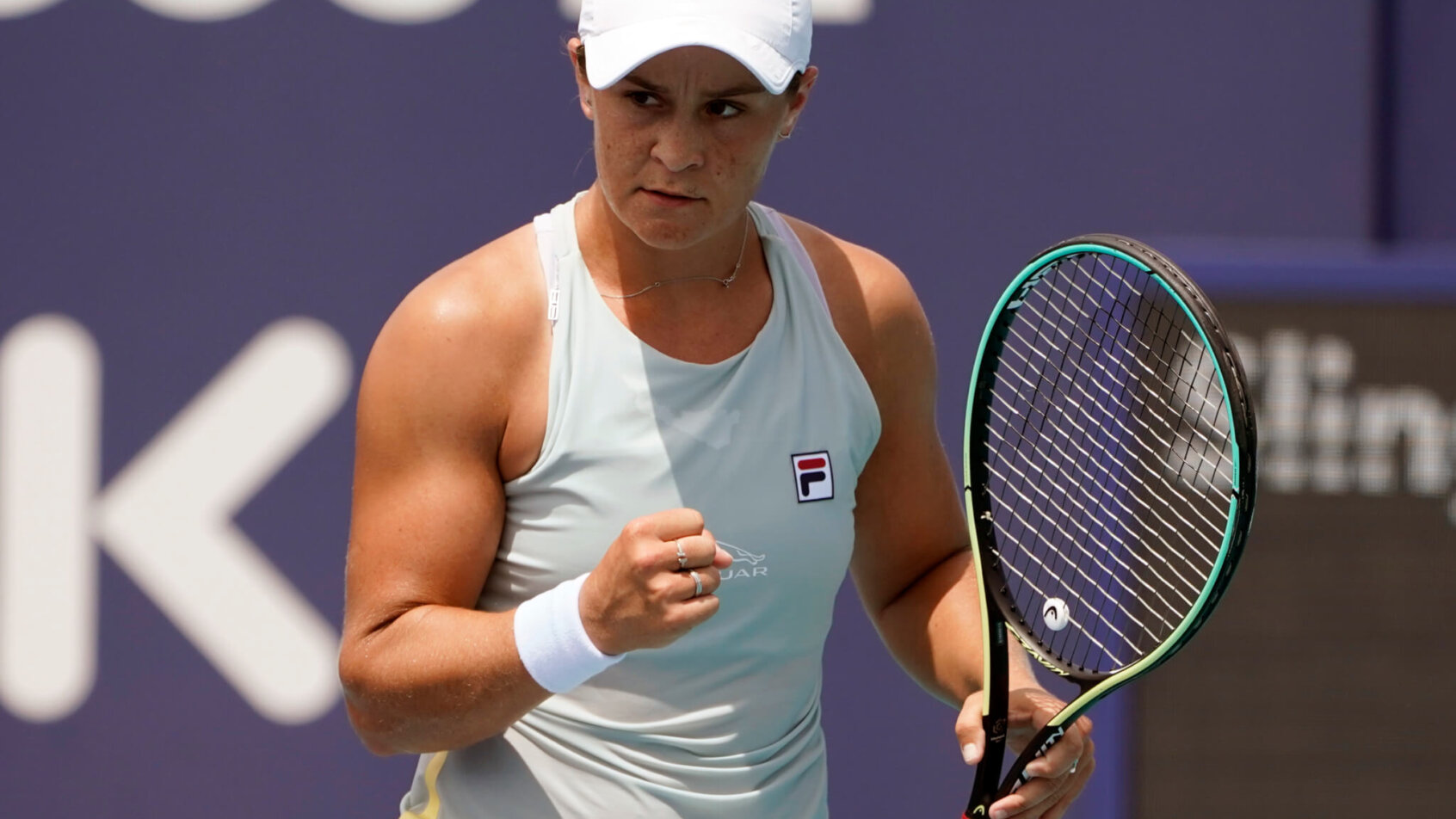 Ashleigh Barty celebrating a point with a first pump during a tennis match.