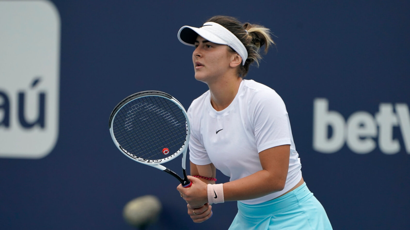 Bianca Andreescu waiting to return a serve during a tennis match.