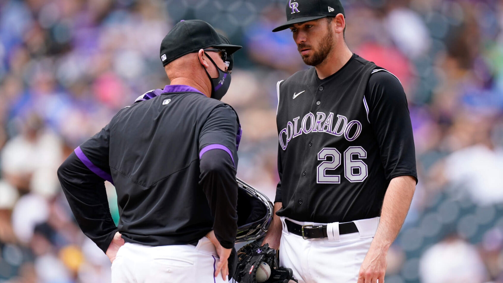 Austin Gomber talking to the Rockies' pitching coach on the mound