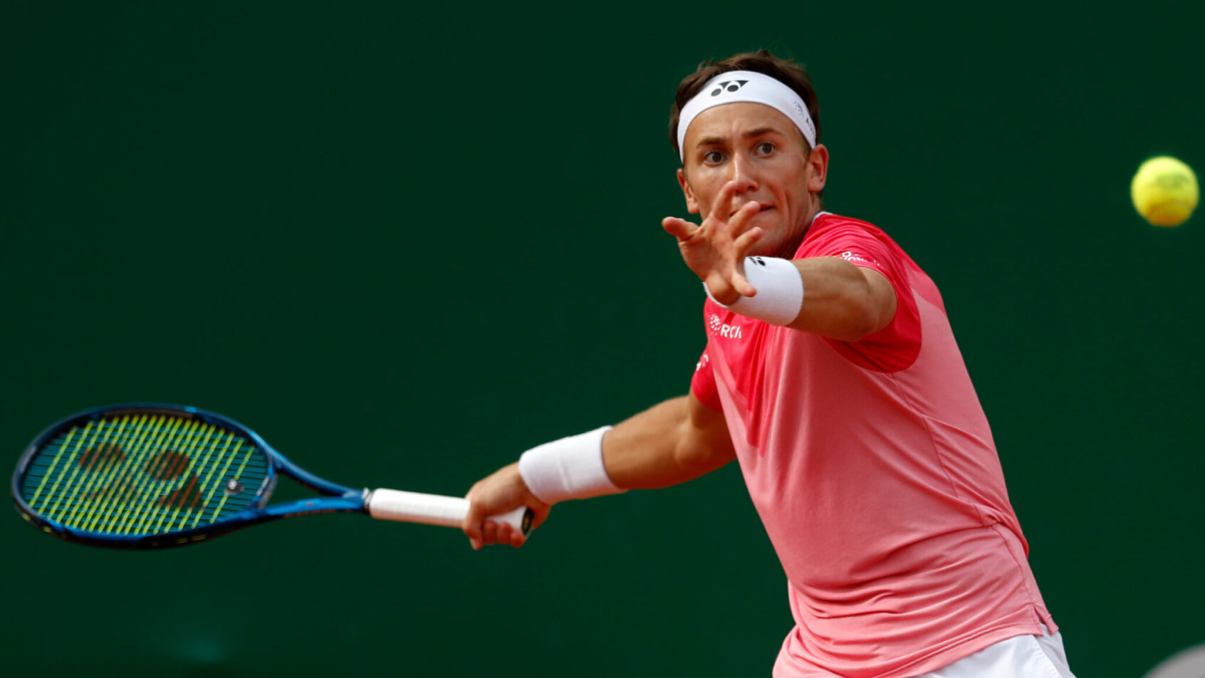 Casper Ruud hitting a forehand return during a tennis match.