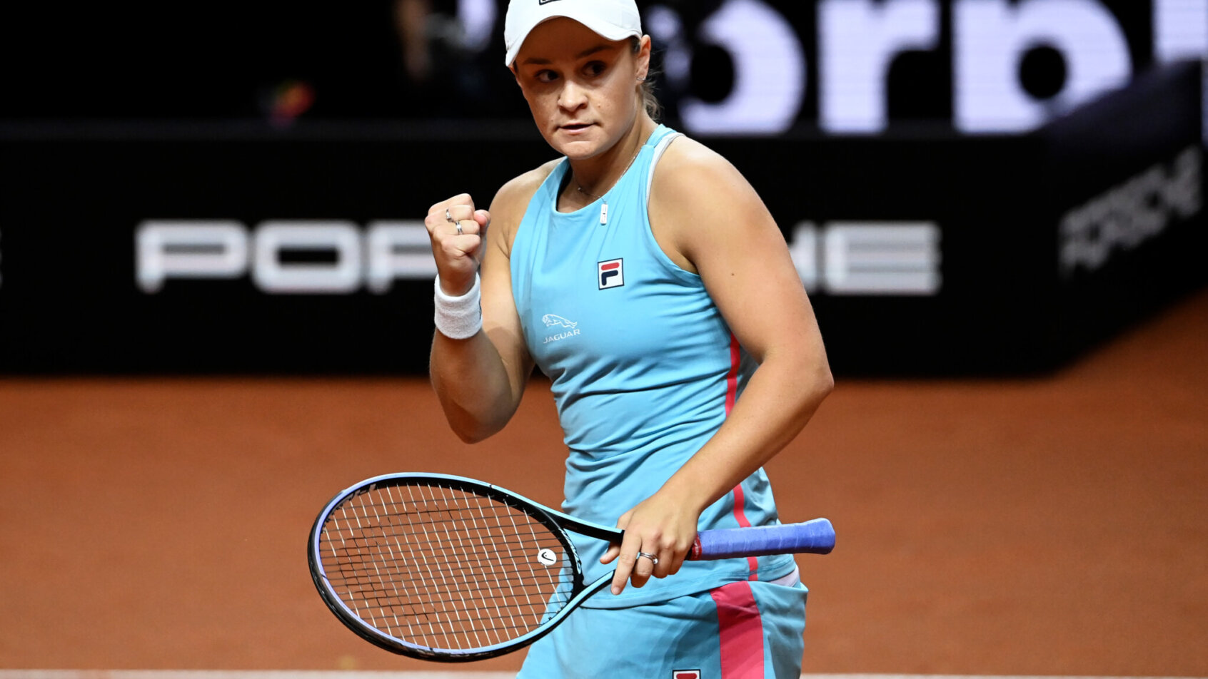 Ashleigh Barty reacting with a fistpump after scoring a point during a tennis match.