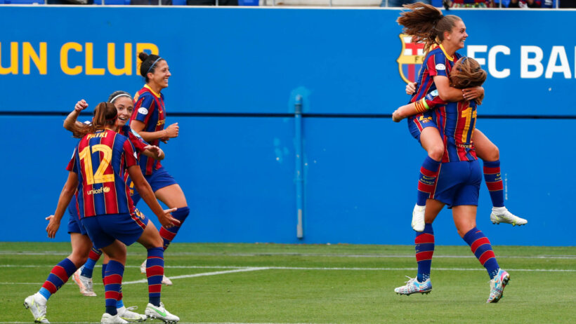 Barcelona players running and congratulated each other after scoring a goal during a soccer match.
