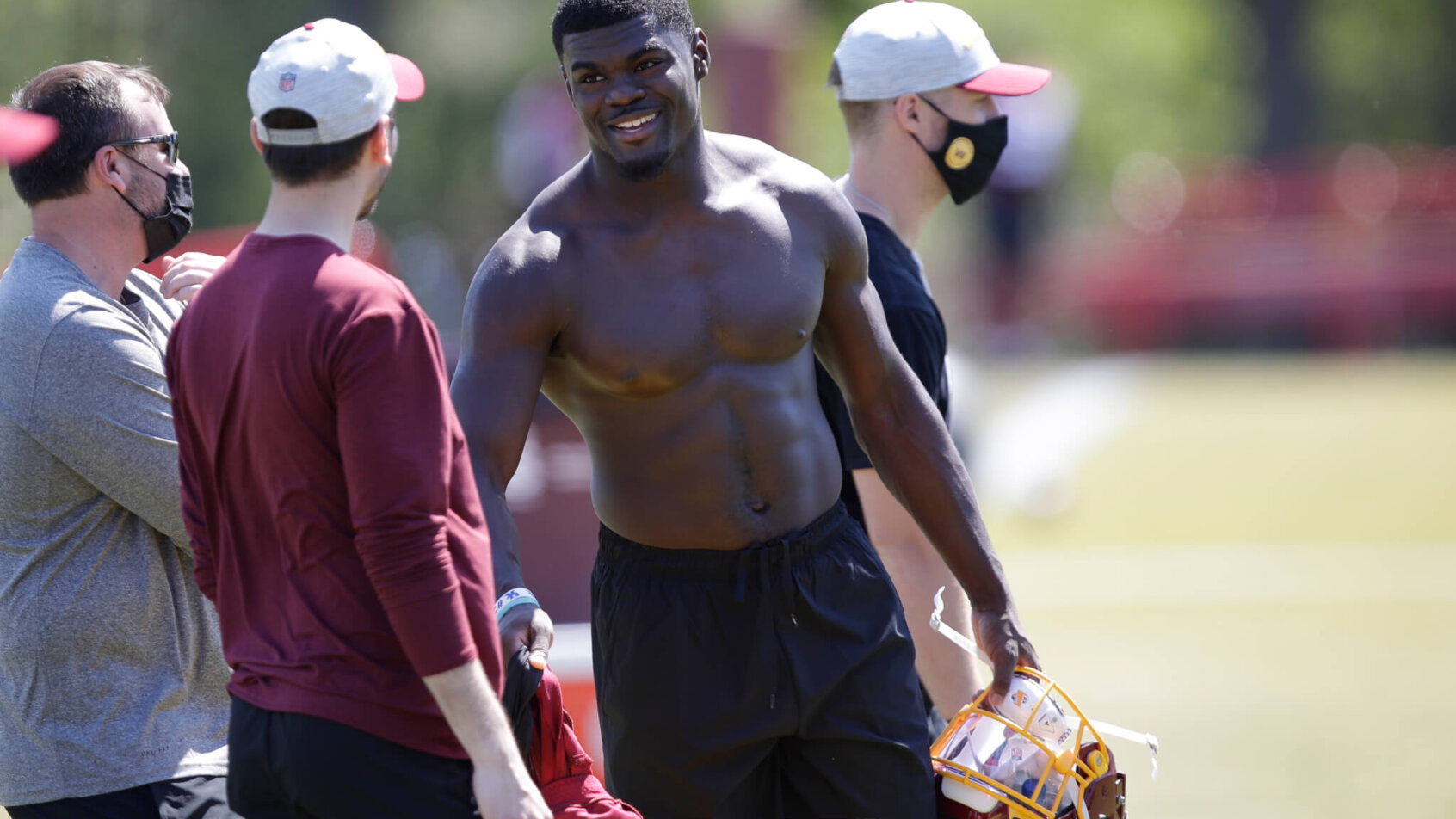 Jamin Davis talking to members of the Washington coaching staff