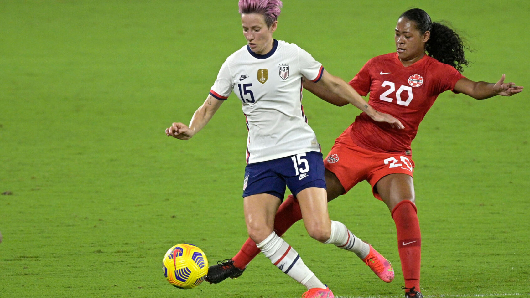 Megan Rapinoe and Jayde Riviere battle for ball