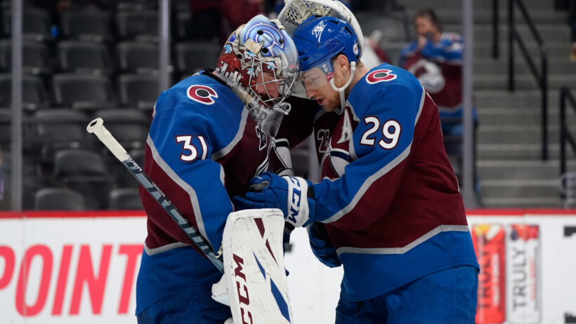 Philipp Grubauer and Nathan MacKinnon hug