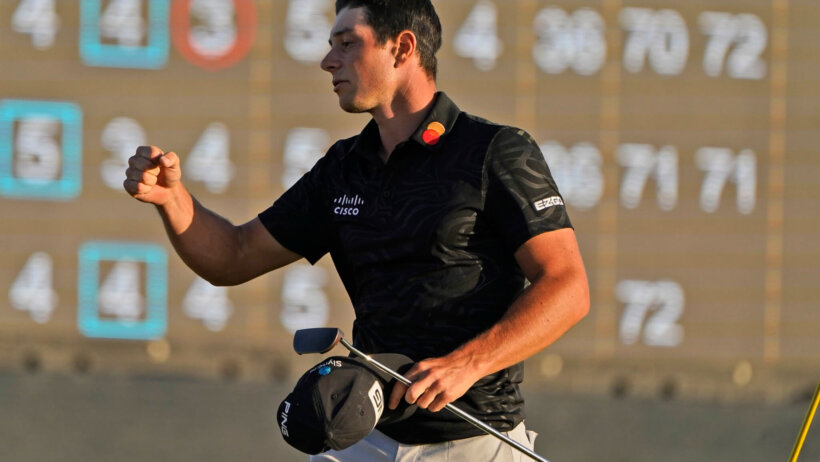 Viktor Hovland celebrates after his round