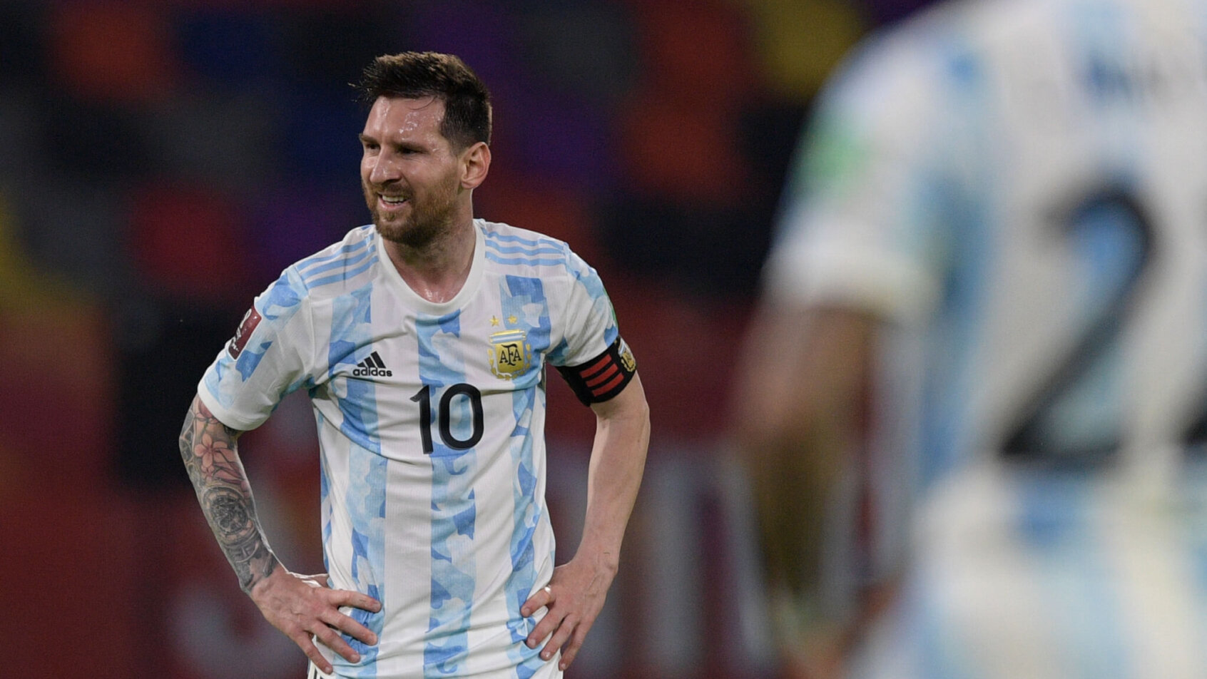 Lionel Messi with his hands on his hips during a soccer match.