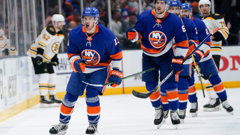 New York Islanders' Mathew Barzel celebrating with teammates after a goal during a NHL playoff game.