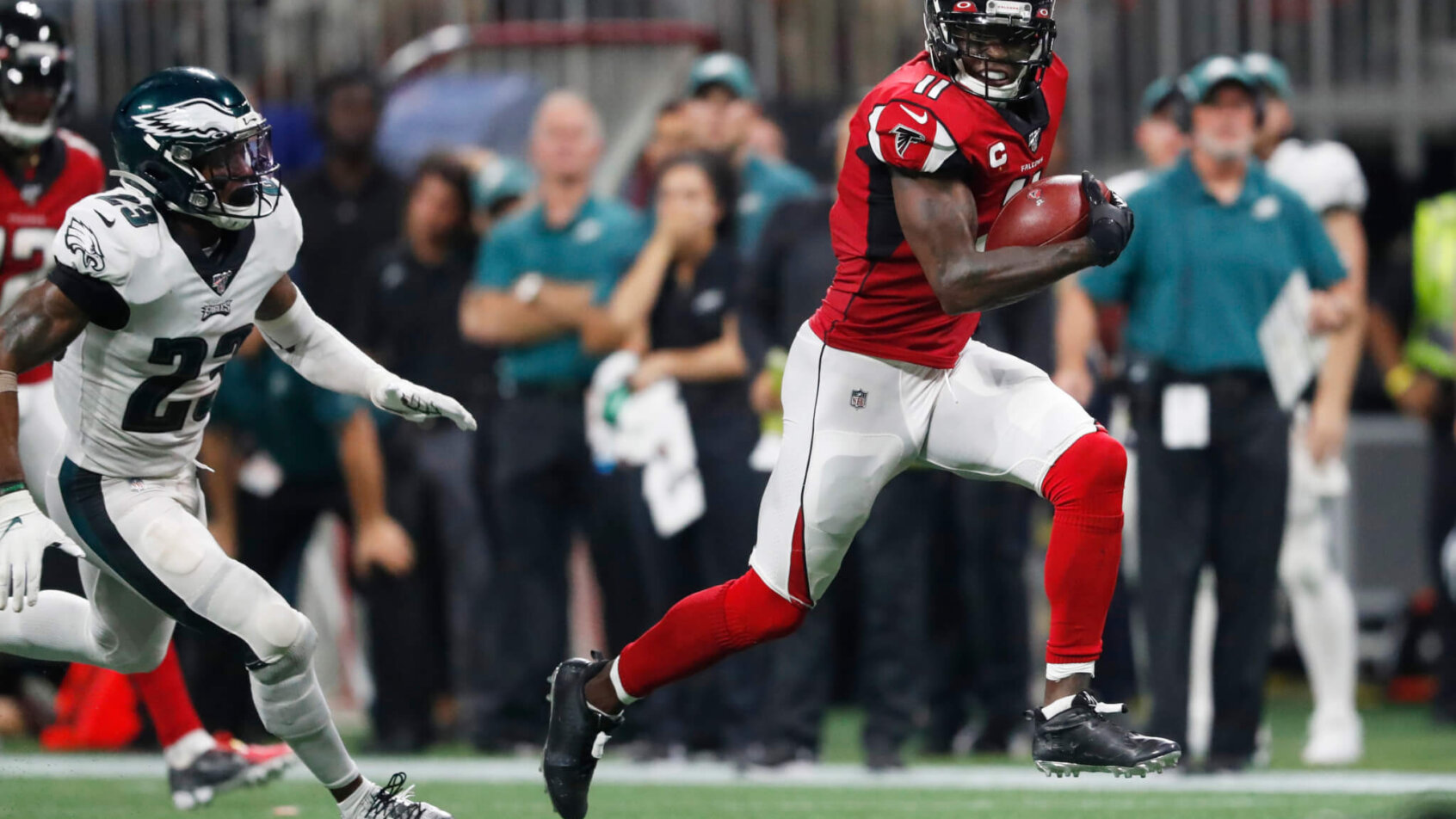 Julio Jones running towards the end zone for a touchdown during a football game.