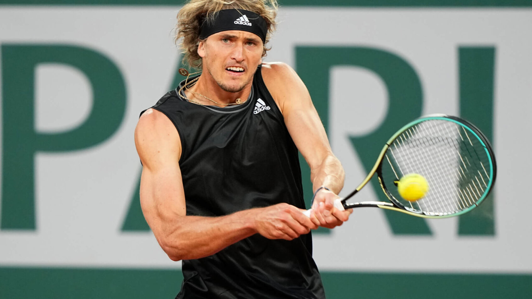 Alexander Zverev hitting a return to his opponent during a tennis match.