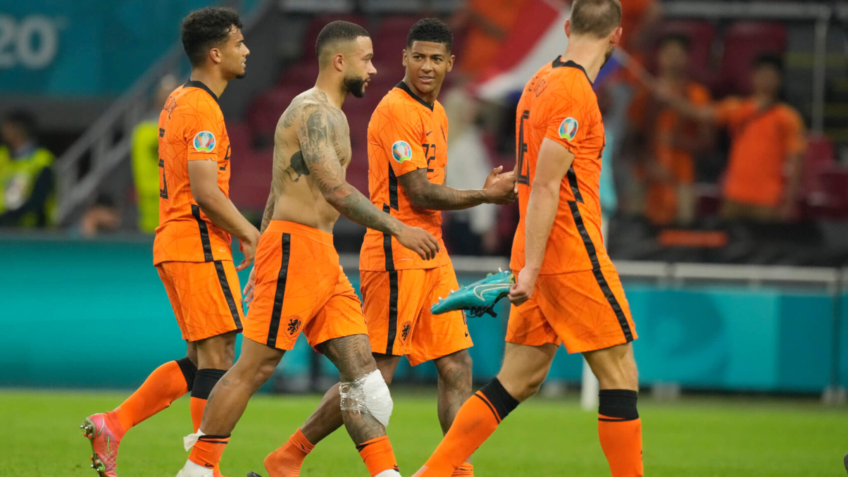 Netherland players walking off the field after winning a soccer match.