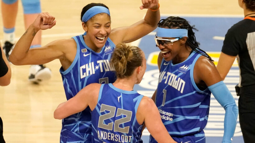 Candace Parker arms raised, celebrating with teammates