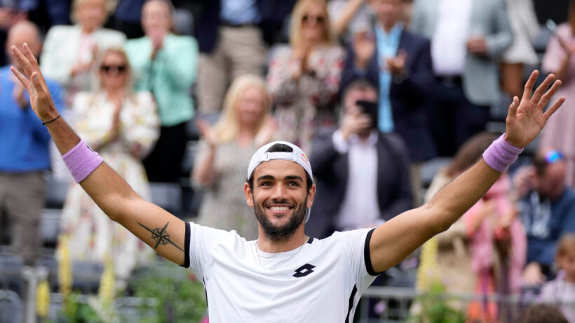 Matteo Berrettini celebrating after winning a tennis match at the Queen's Club tournament.