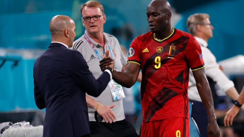 Belgium manager Roberto Martinez greets Romelu Lukaku