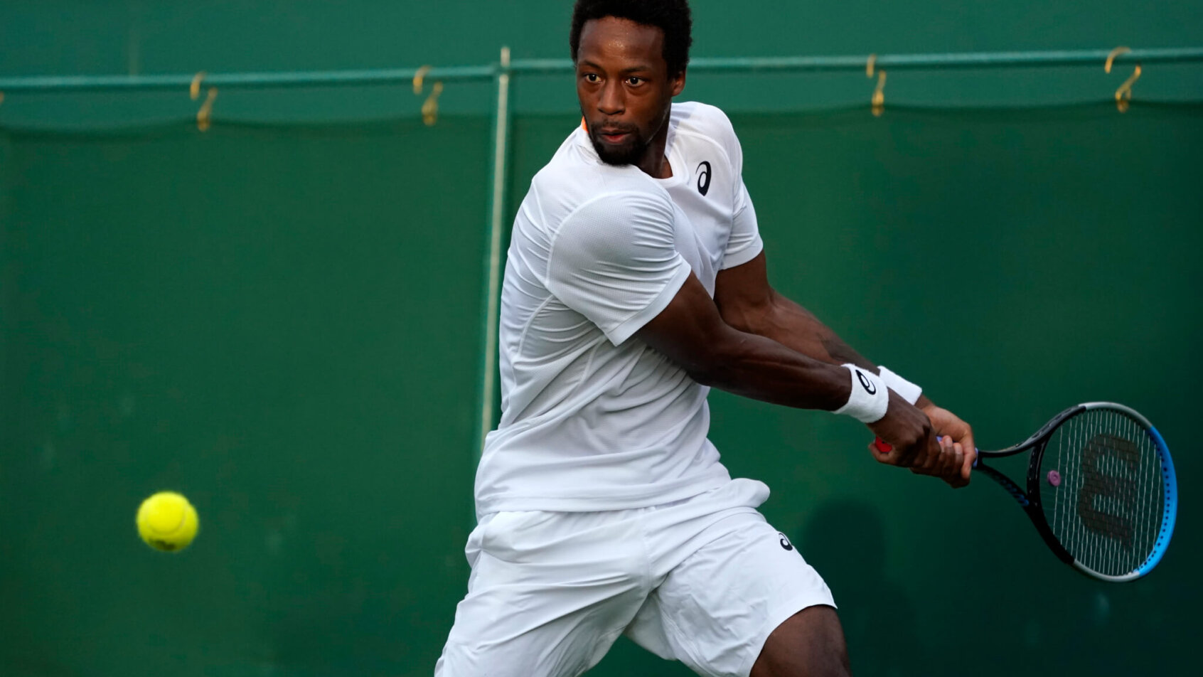 Gael Monfils returning the ball during a tennis match at Wimbledon.