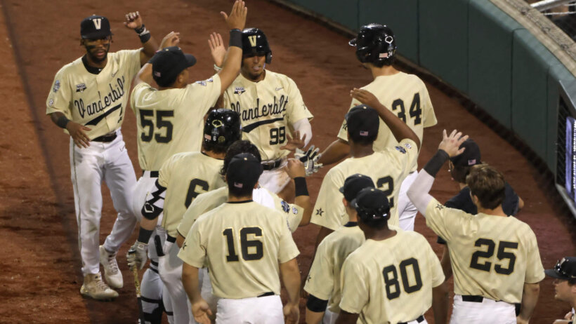 The Vanderbilt baseball team celebrating by their dugout