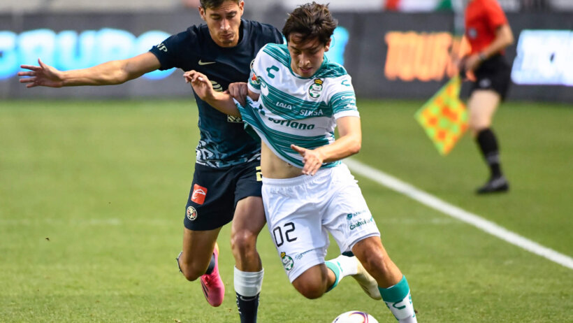 Two players battling for the soccer ball