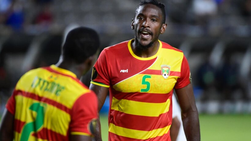 Grenada players talking on the pitch